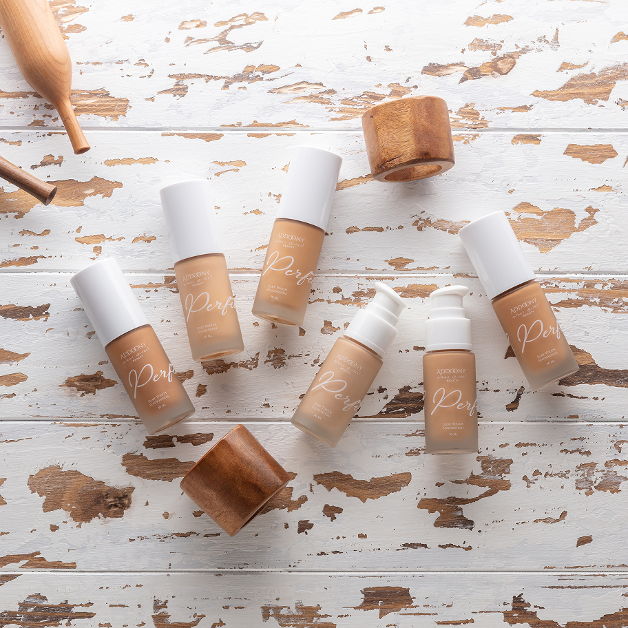foundation bottles with wooden caps on a rustic wooden surface