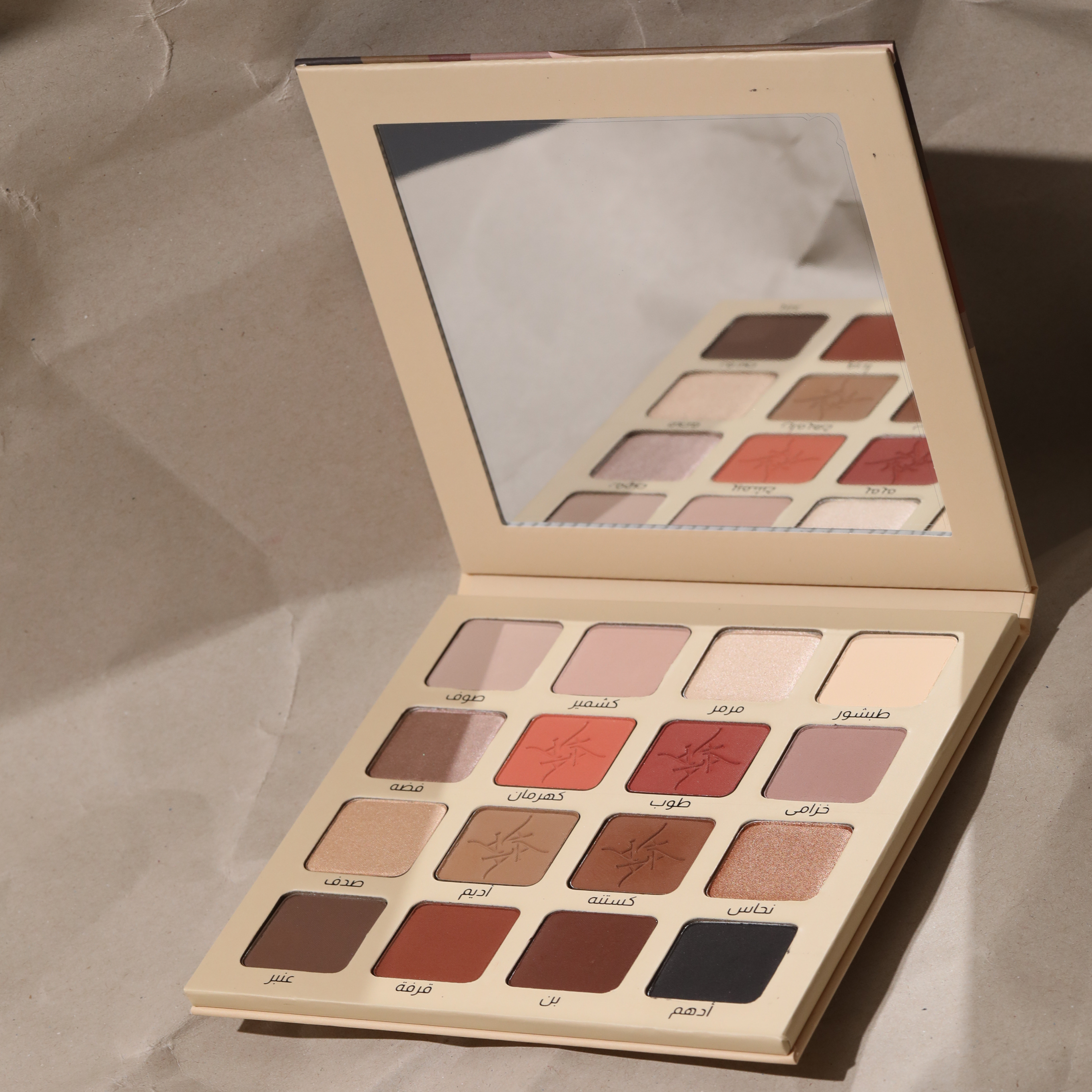 Makeup palette with various shades on a textured surface