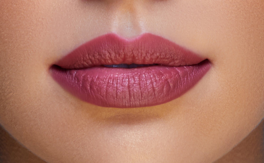 Addoony Beauty lipstick in medium shade, featuring a sleek tube and vibrant color, perfect for a bold lipstick look.