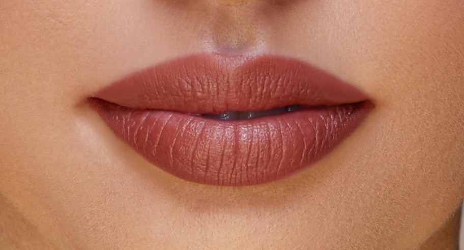 Addoony Beauty Deem lipstick in a light shade, showcasing a sleek tube with the lipstick partially extended.