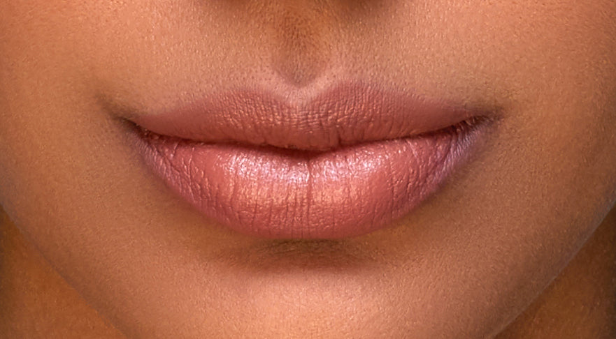 Addoony Beauty Fitna lipstick in a tan shade, showcasing the sleek lipstick tube and the vibrant color of the product.