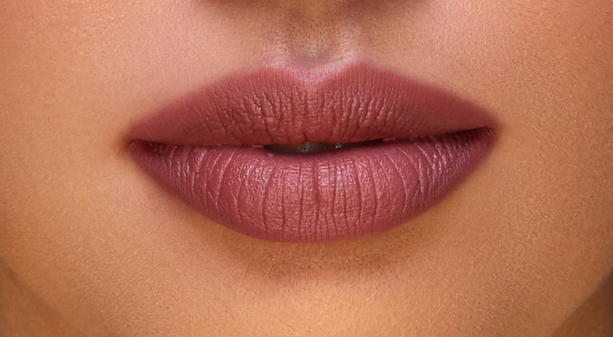 Addoony Beauty Indian Rose lipstick in a light shade, showcasing a smooth, elegant lipstick bullet with a soft pink hue.