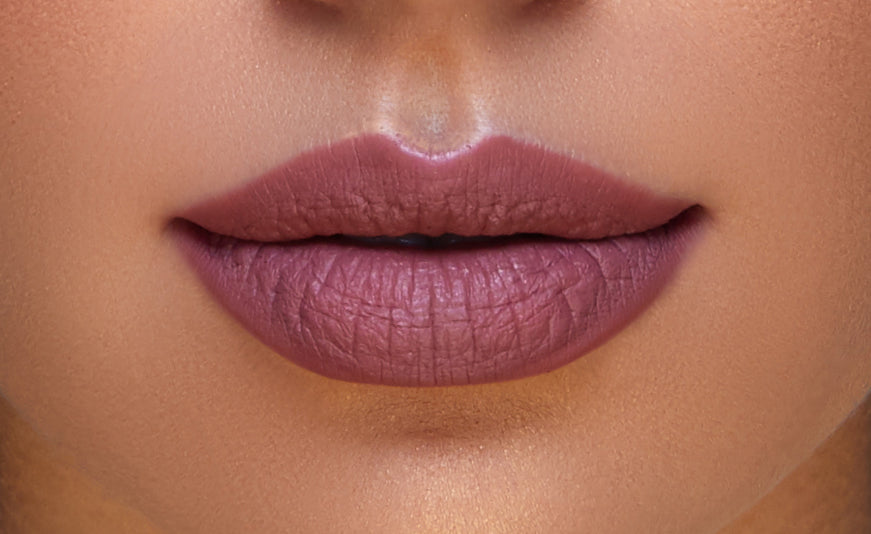 Addoony Beauty Indian Rose lipstick in medium shade, showcasing vibrant pinkish-red color and smooth bullet application.