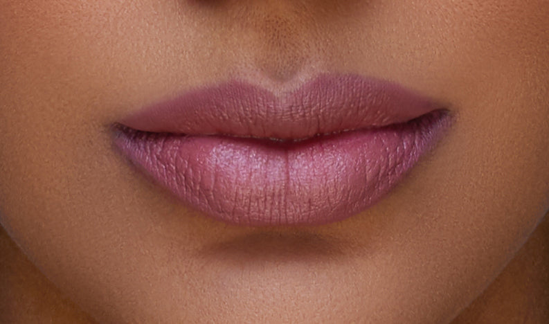 Addoony Beauty Indian Rose lipstick in a sleek tube, featuring a rich pink shade named Indian Rose, with a tan-colored cap.