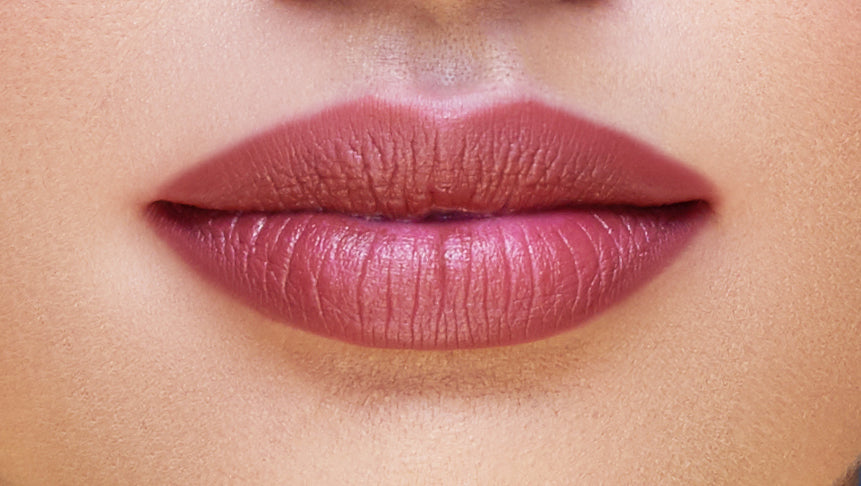 Addoony Beauty Proven Lipstick in Qataf shade, featuring a sleek lipstick tube and a swatch of soft pink lipstick on the skin.