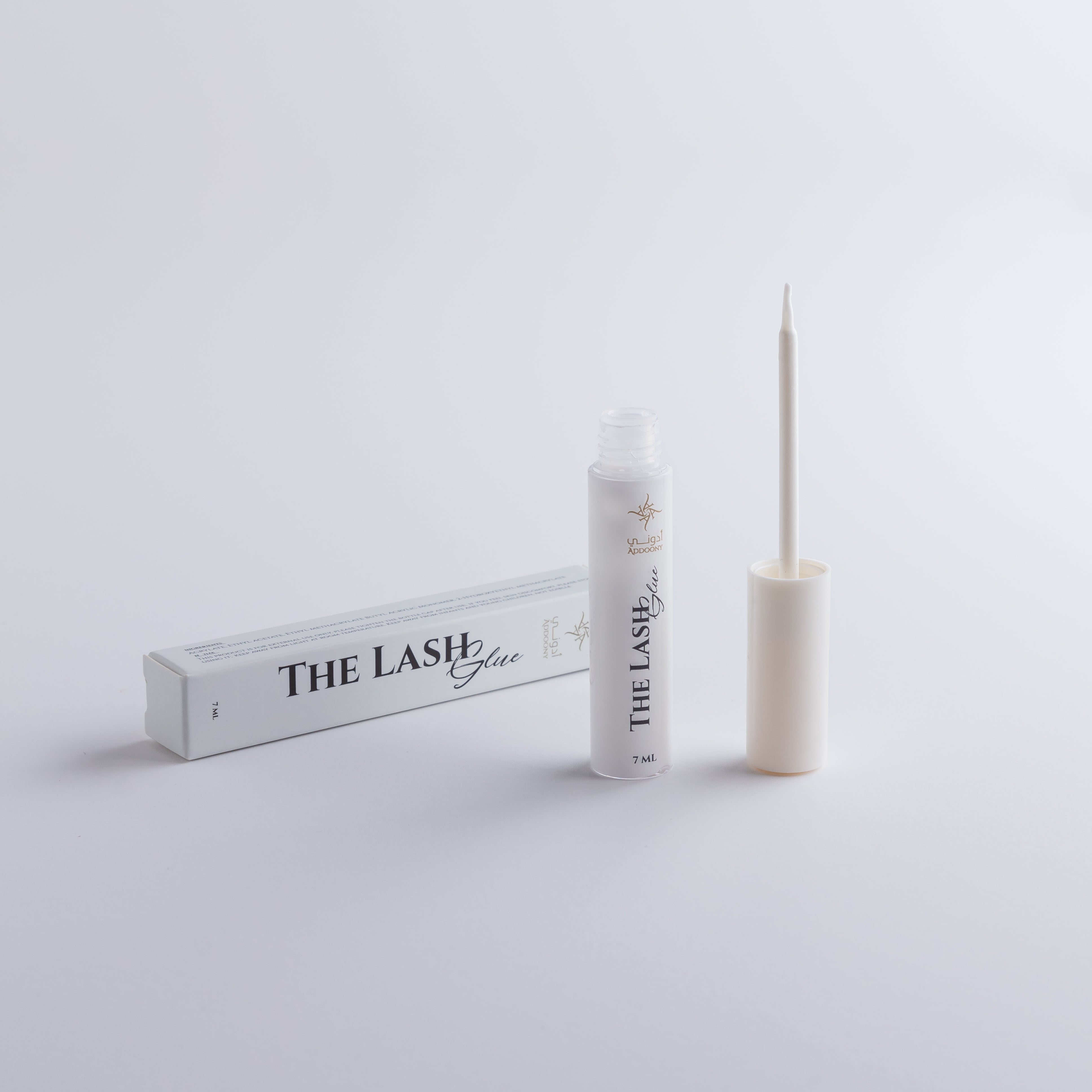 Lash glue with packaging on a light gray background