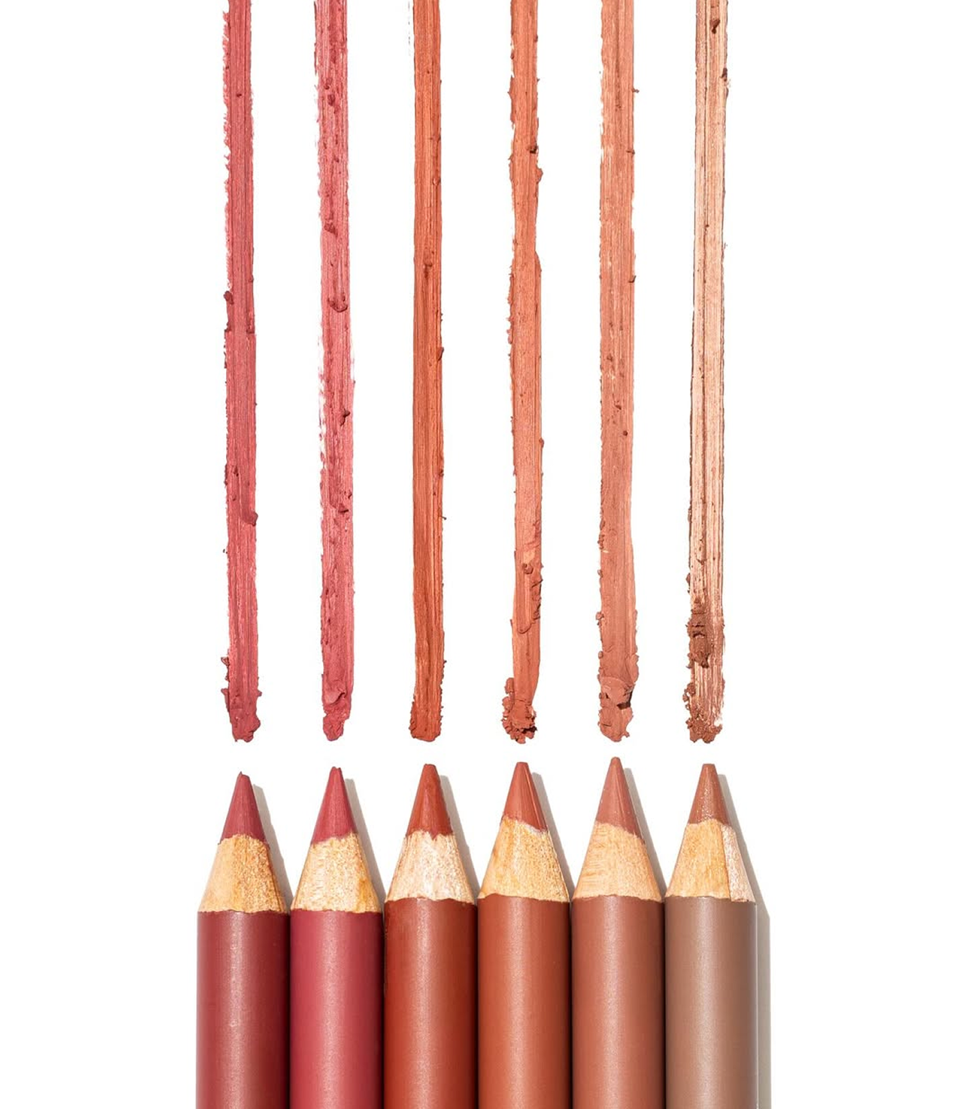 Set of lip pencils with color swatches on a white background