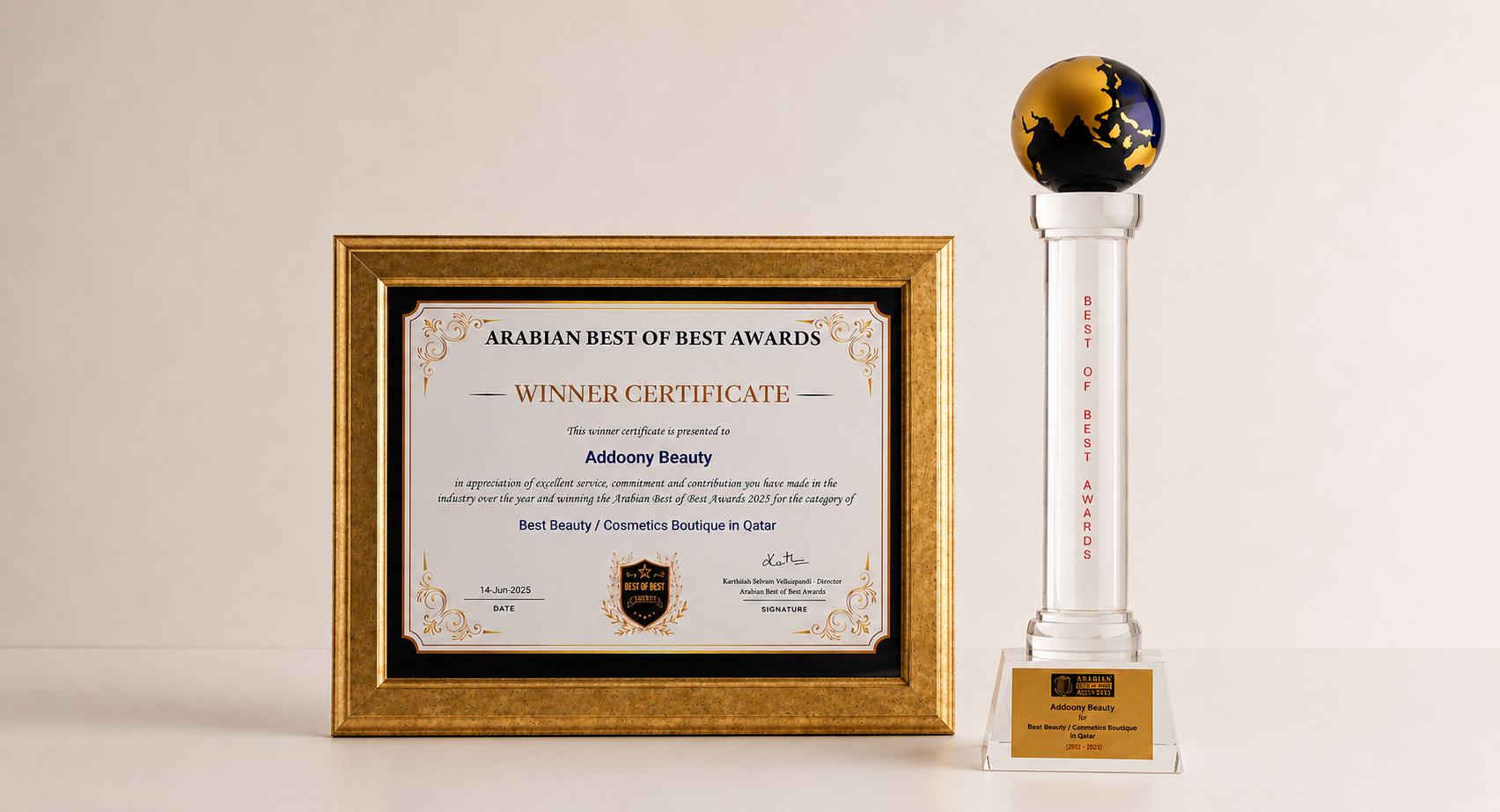 A framed award certificate and a tall trophy with a globe-shaped top stand on a light beige background. The certificate is in a gold frame, and the trophy has a clear column, gold base, and a black-and-gold globe ornament.