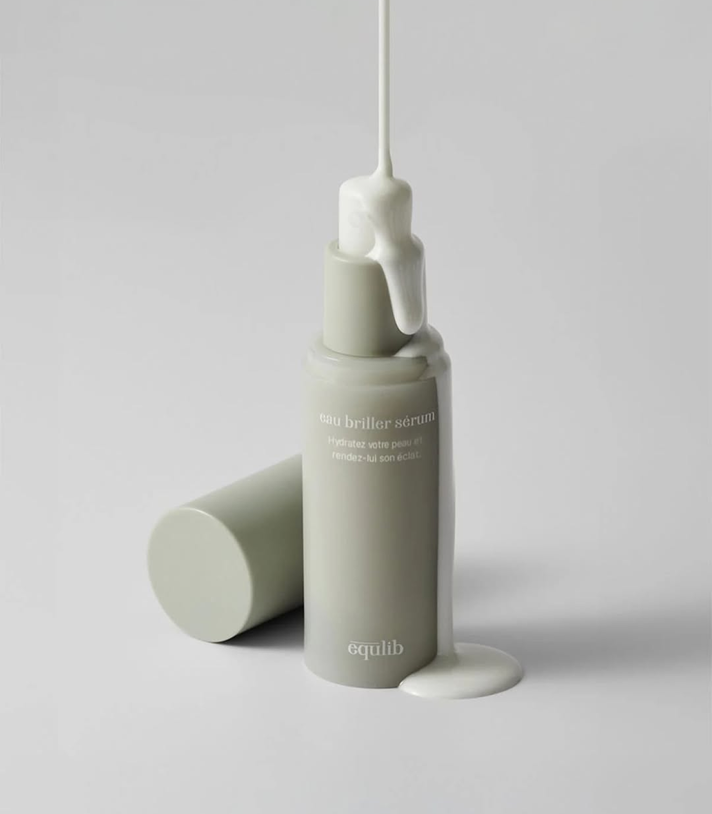 Skincare serum bottle with dropper on a light gray background
