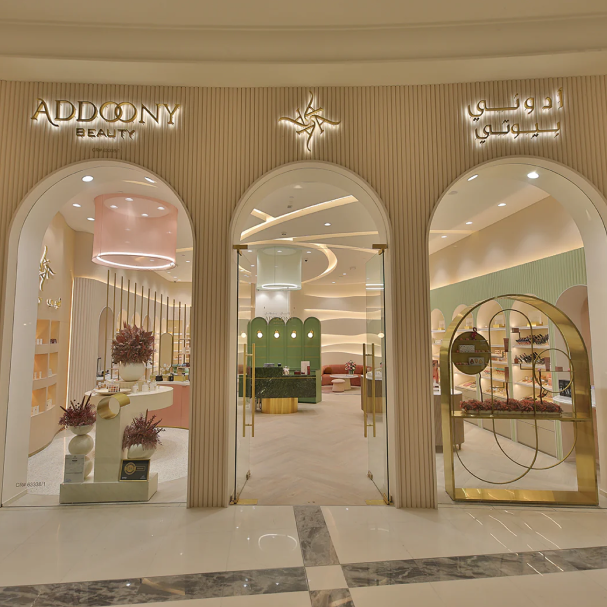 Luxurious store interior with 'Addoony' branding, featuring elegant decor and reflective surfaces.