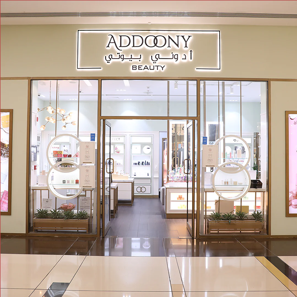 Storefront of Addoony Beauty with glass doors and interior display.