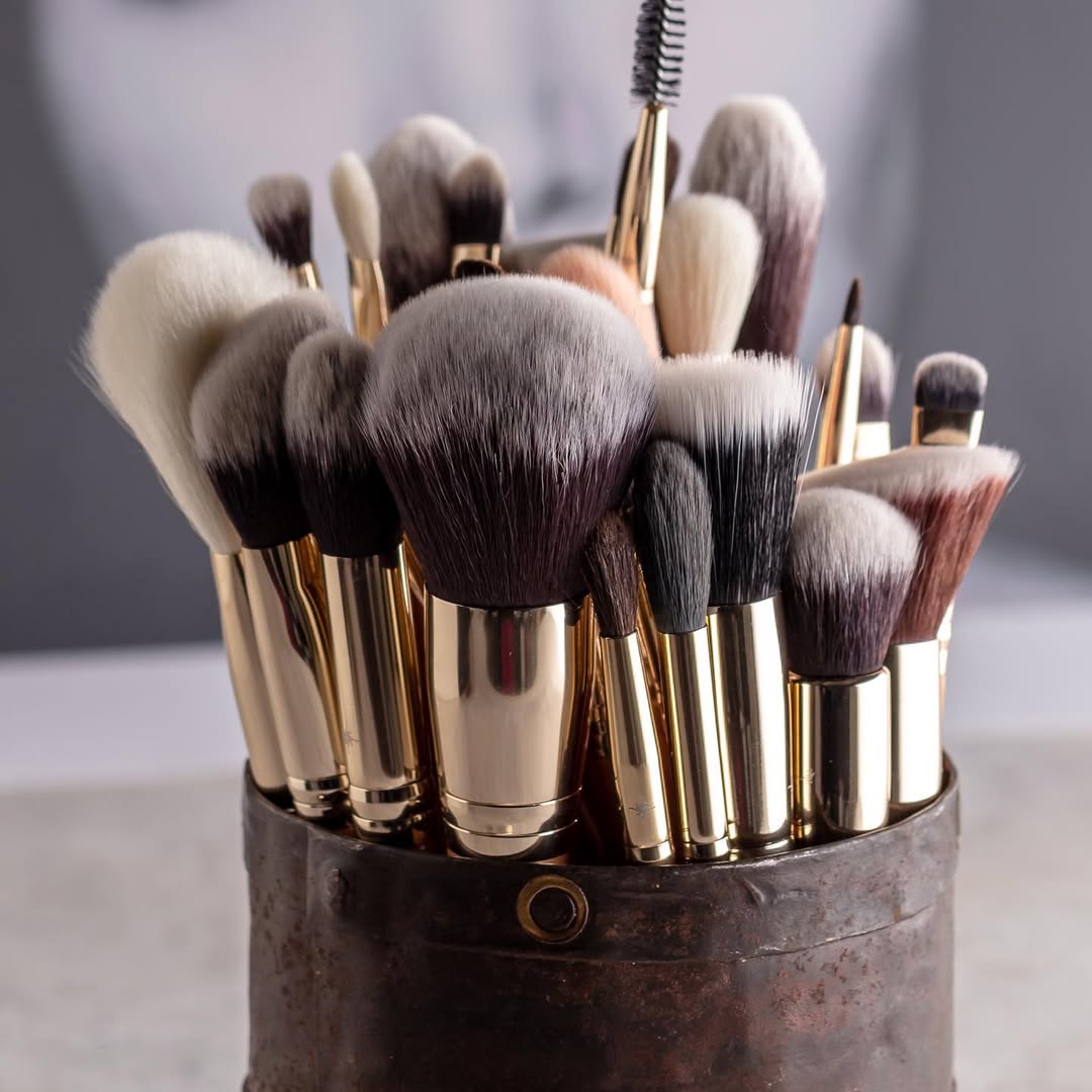 Set of makeup brushes in a holder on a blurred background