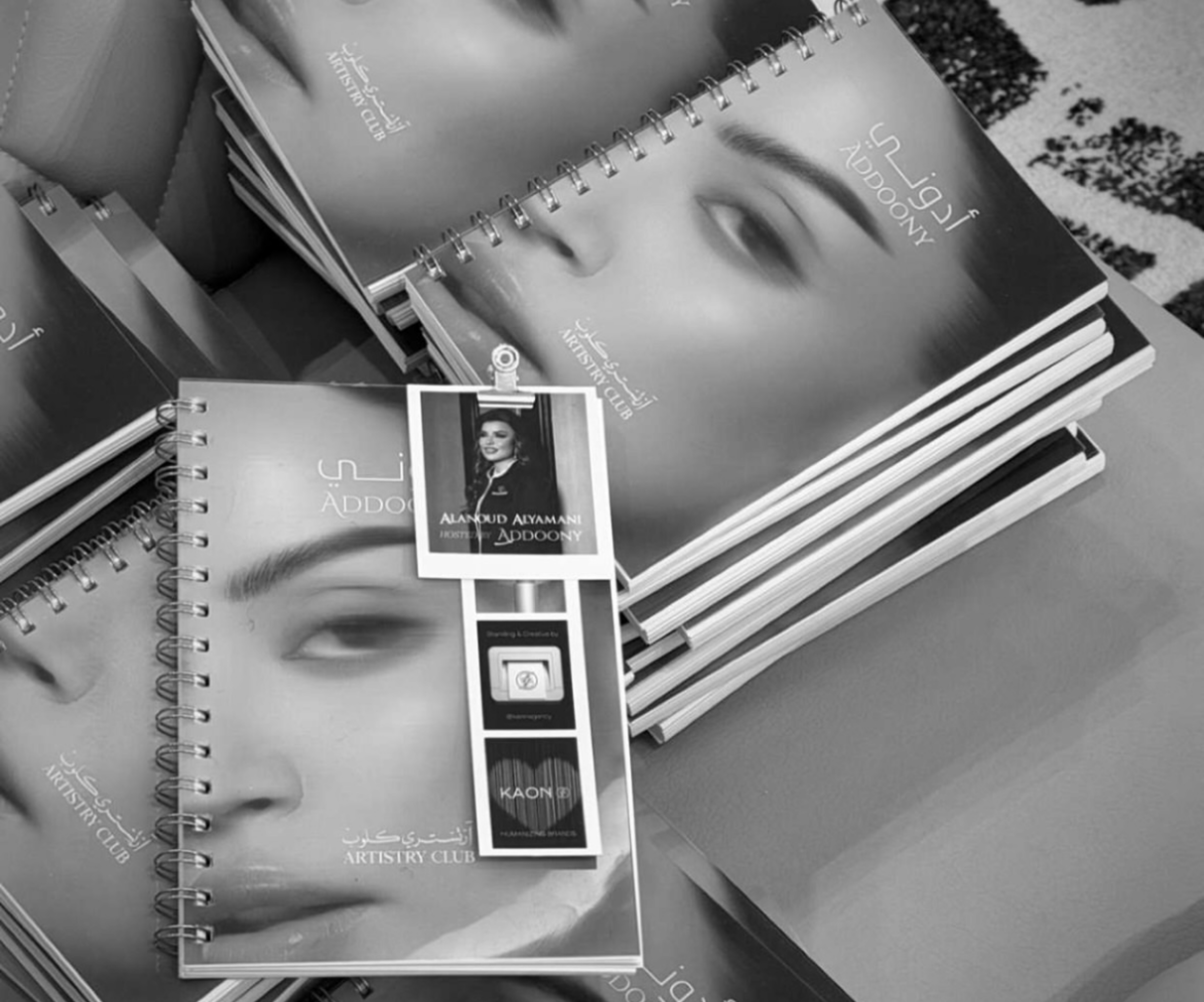 Stack of notebooks with a face design on the cover, featuring the brand 'Aubade'.