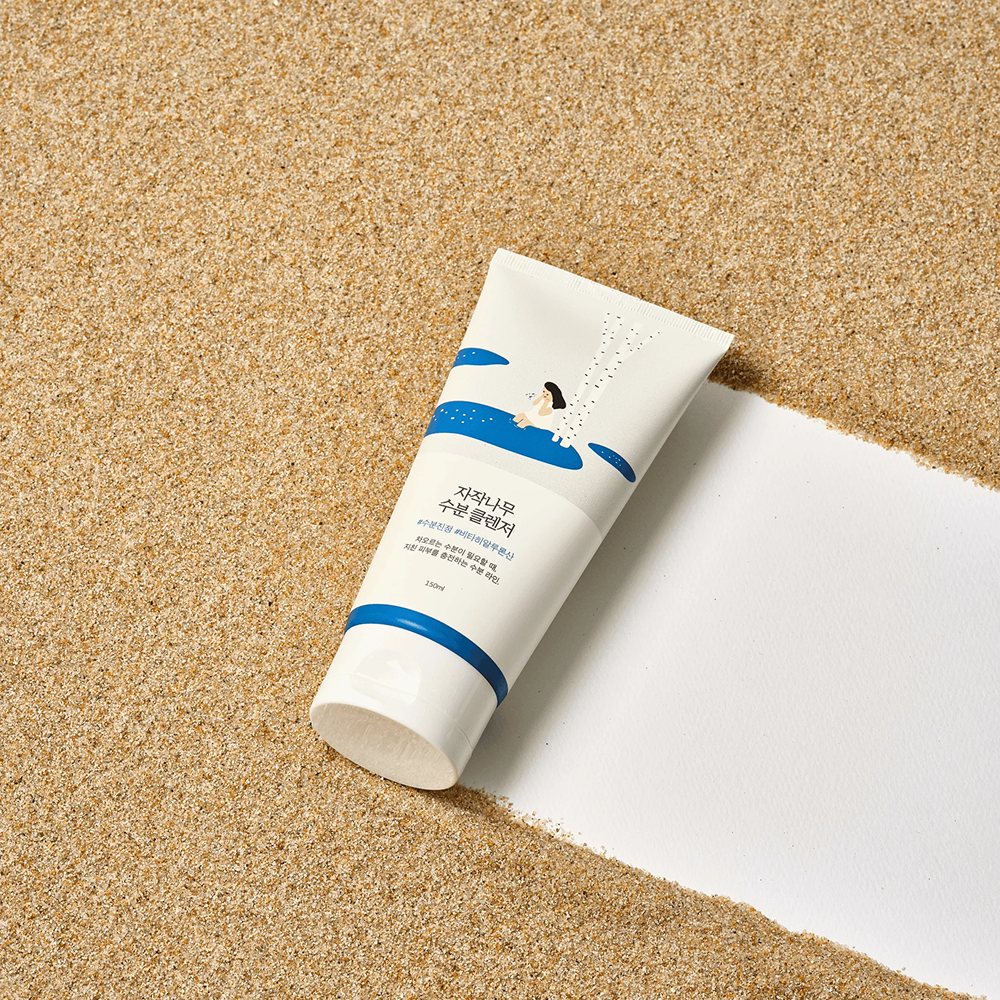 bottle of hand cream on the sand