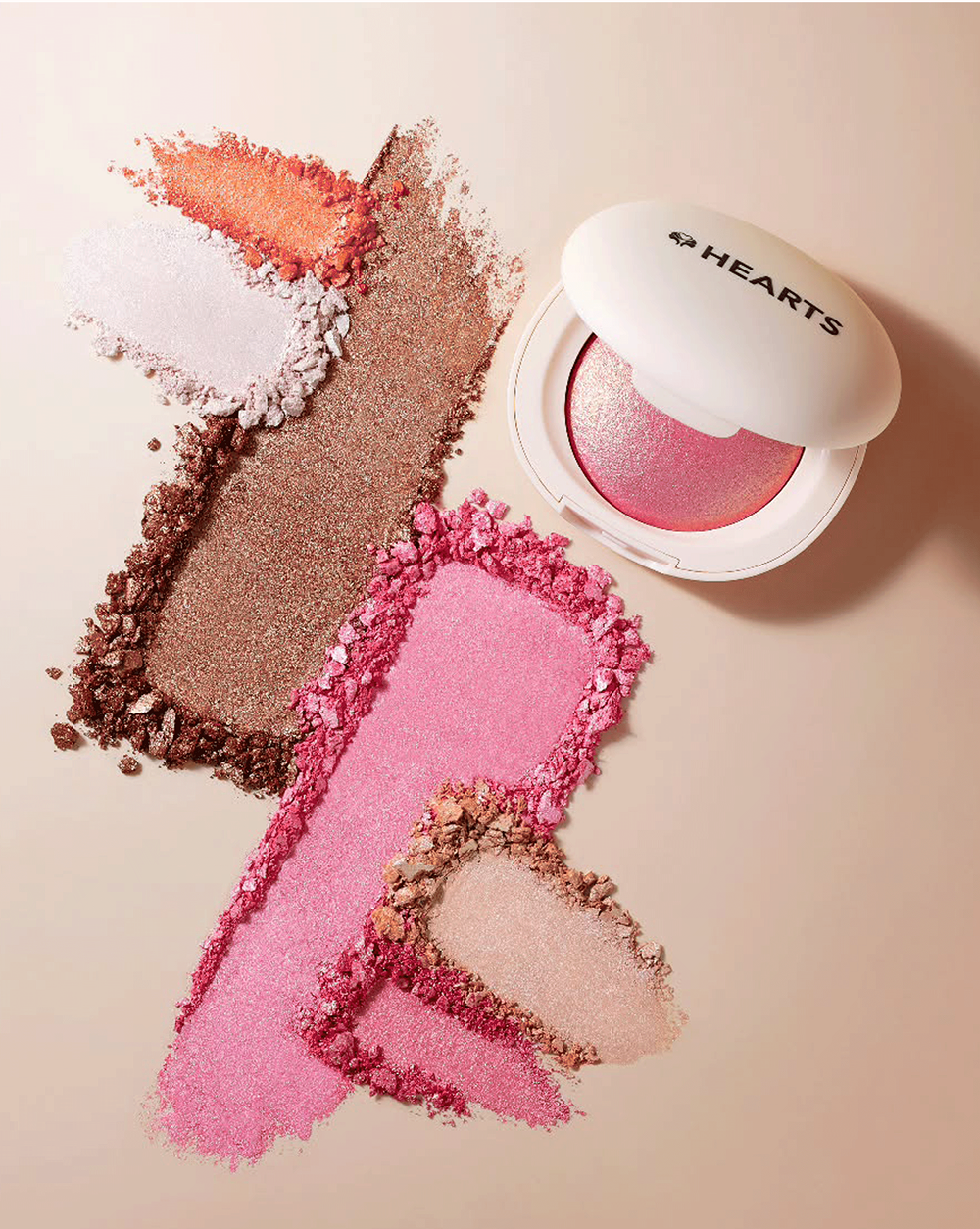 Makeup product with pink and brown shades on a light background