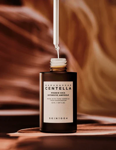 Skincare bottle labeled 'Madagascan Centella' with a blurred background