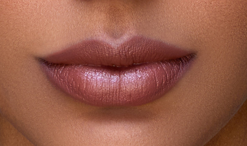 Addoony Beauty Proven Lipstick in Deem shade, tan-colored lipstick tube with the product name visible.