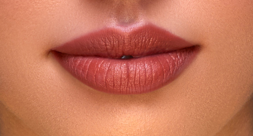 Addoony Beauty Fitna lipstick in a sleek tube, showcasing the light-colored lipstick bullet ready for application.