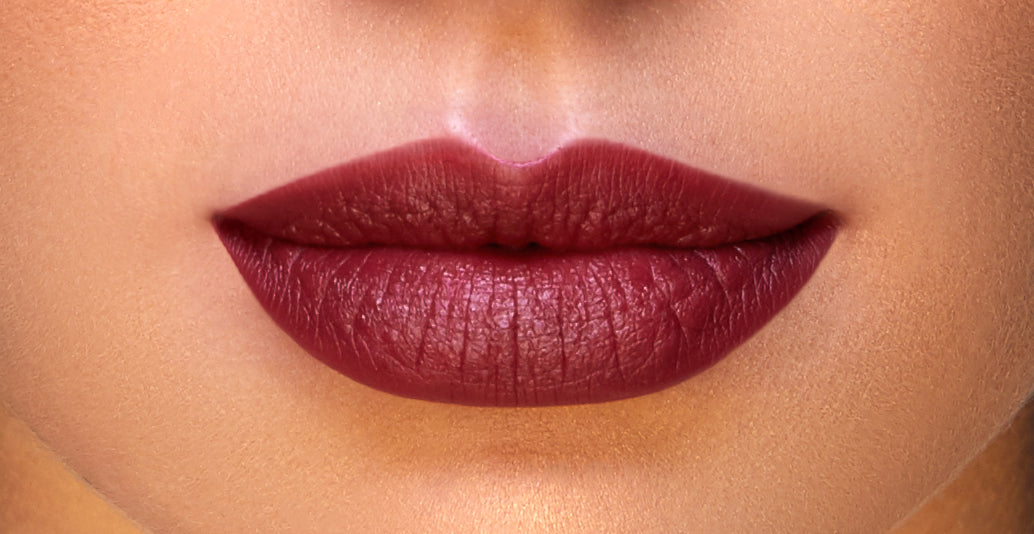 Addoony Beauty Taulah lipstick in medium shade, featuring a sleek tube and visible product label on the lipstick stick.
