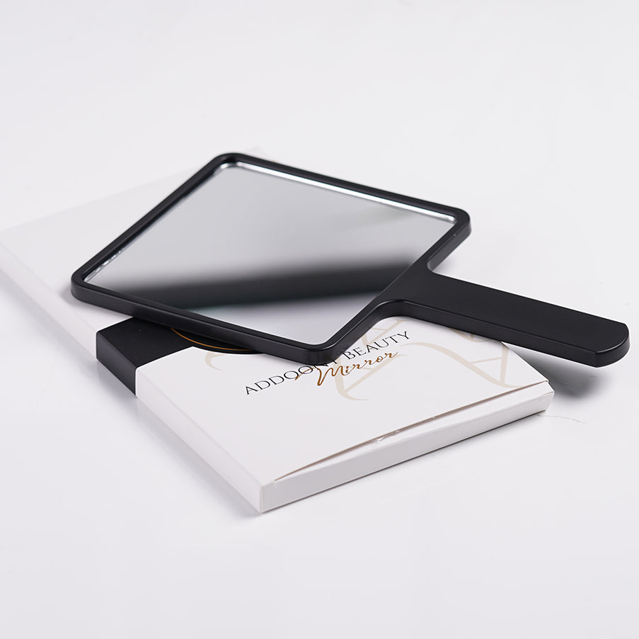 Addoony Beauty Gifts handheld mirror with handle, compact tool for makeup and grooming, featuring a reflective surface and ergonomic design.